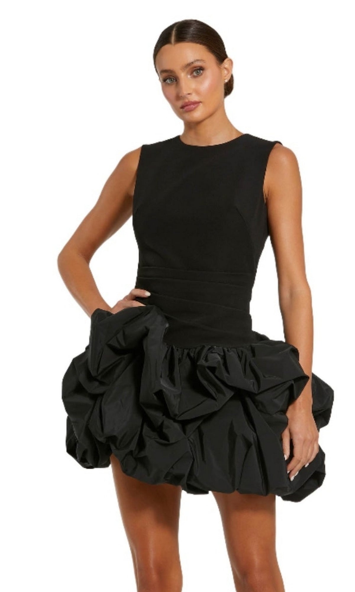 Woman in the Mac Duggal 20709 Short Black Bubble Party Dress, featuring a fitted bodice and voluminous mini bubble skirt, stands against a plain white background.